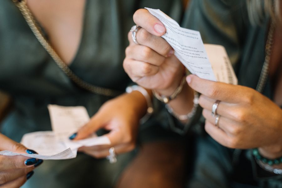 two people holding receipts